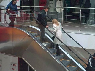 blond woman on an escalator